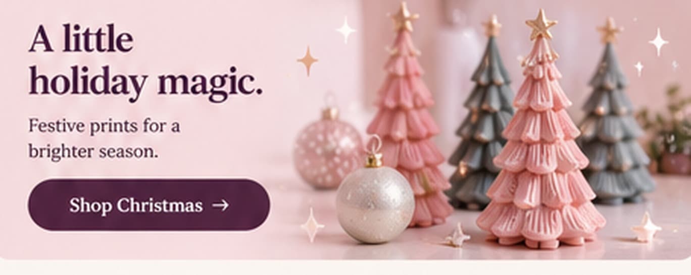 Glowing 3D printed Christmas trees in pink and sage with baubles.